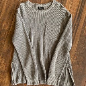 Cable knit sweater with zipper on sides.